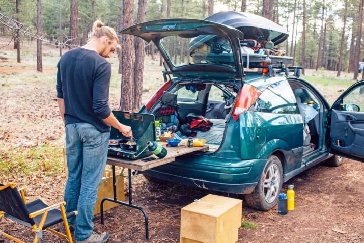 14. Balance a foldable camping table on your bumper to create a kitchen in a small campsite.