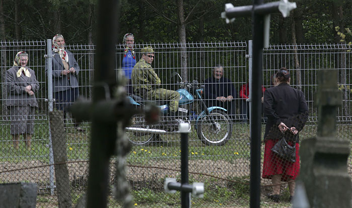 The Woman At Right Is Standing In The Lithuanian Village Of Norviliskes To Speak With Her Belarusian Relatives Across The Fence On The Border Between Belarus And Lithuania