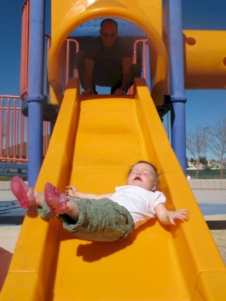 This kid really isn't having as much fun on the slide as they thought they would. 
